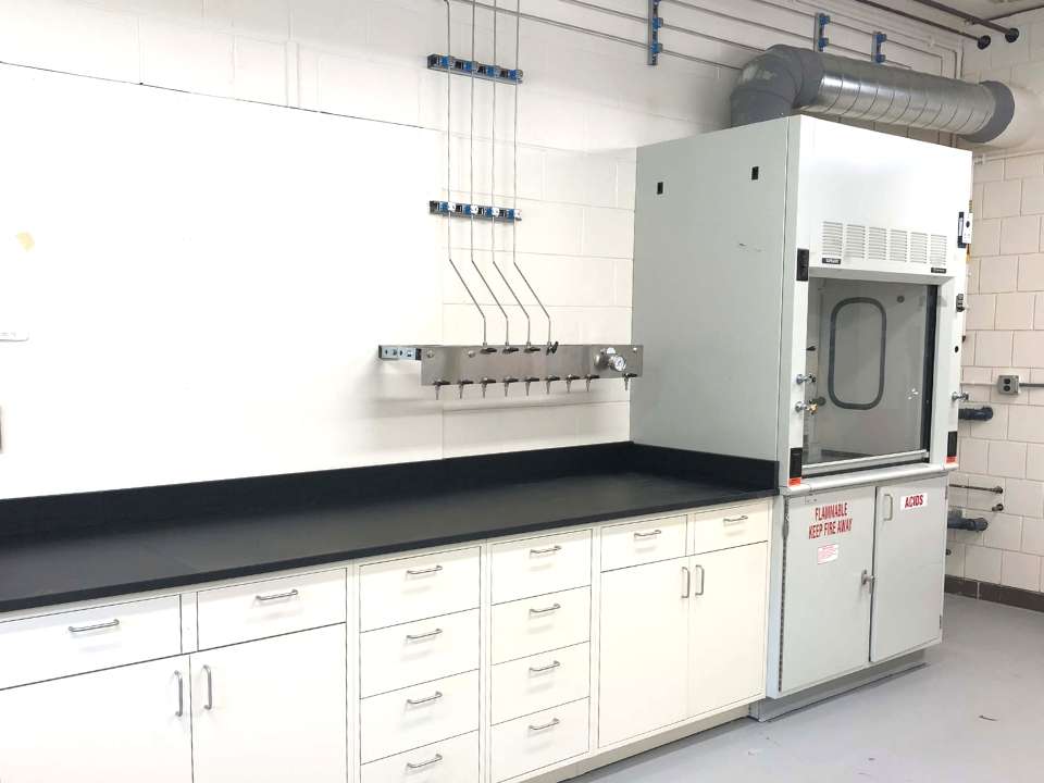 white metal lab cabinets and fume hood