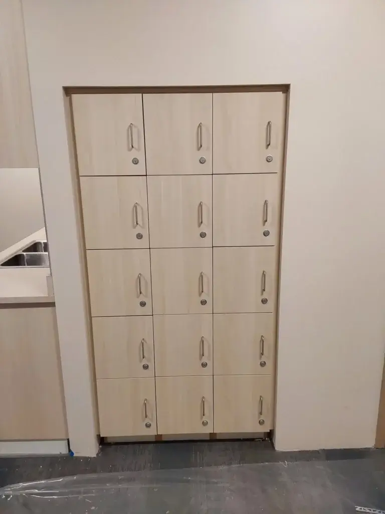 Set of built-in laminate locker cabinets with locks.