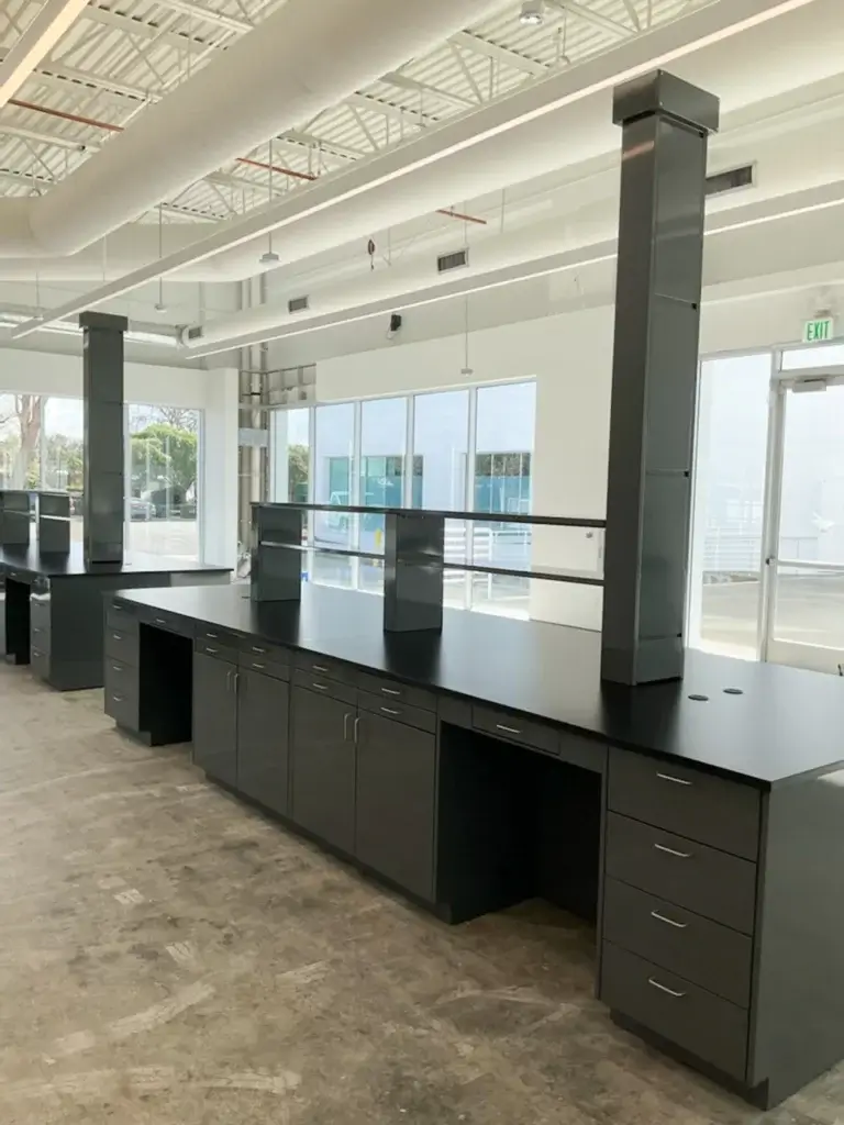 Dark gray powder coated metal casework with shelving.