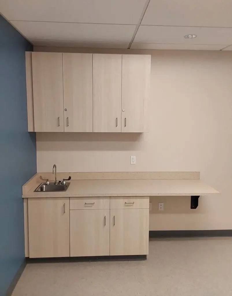 Laminate base cabinets with sink and knee space area.