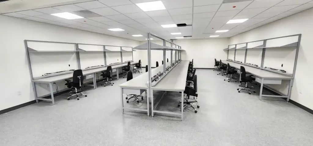 Light grey ESD workbenches in rows.