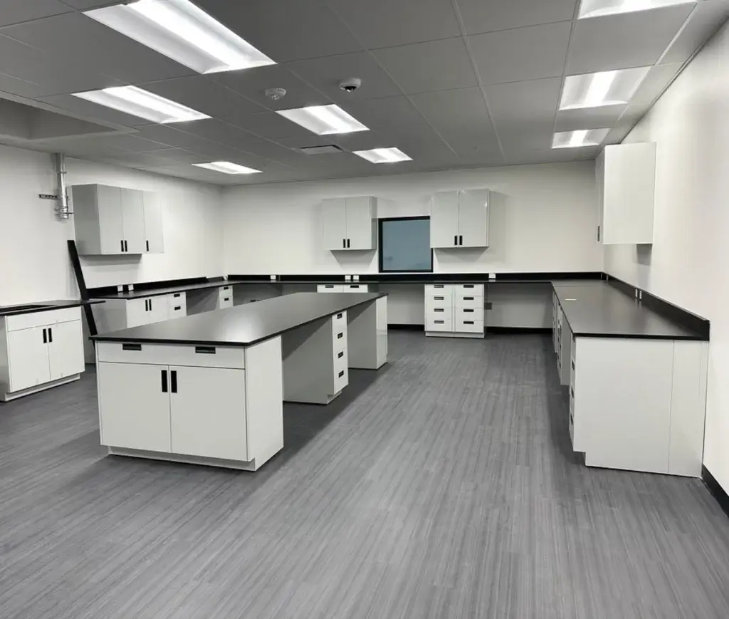 Light grey fixed laboratory island with black phenolic tops.