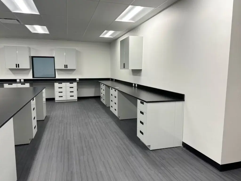Grey powder coated metal cabinets with phenolic resin countertops.