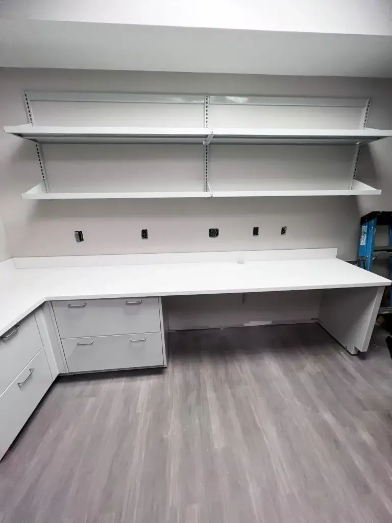 White modular lab wall shelving and cabinets in a lab setting