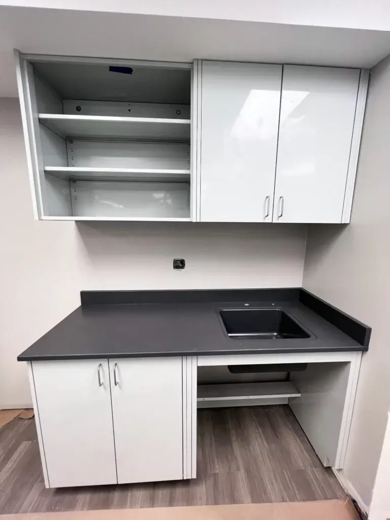 Lab Sink Setup with white metal wall cabinets above and base and ada sink cabinet below