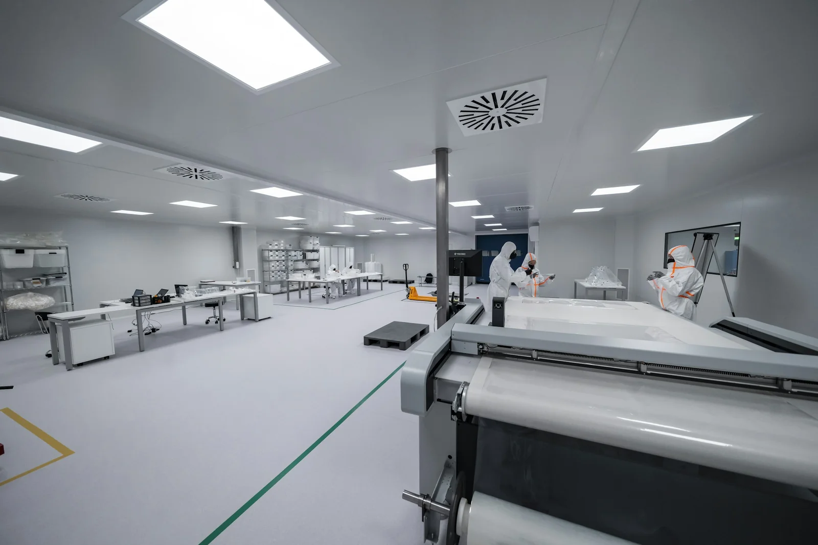 Pharmaceutical cleanroom workers using stainless steel laboratory casework