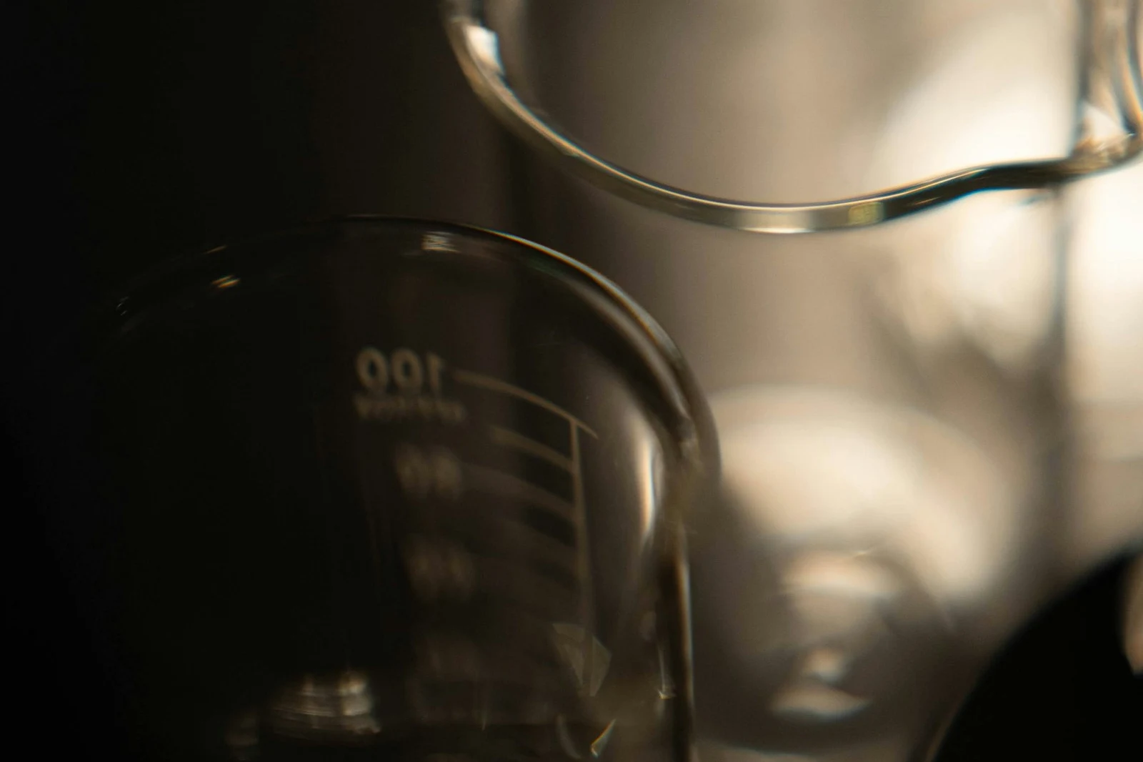 Lab beakers and glassware on a dark epoxy resin worksurface